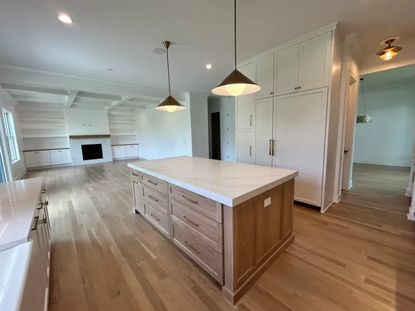 a kitchen with stainless steel appliances a stove a sink and a wooden floor