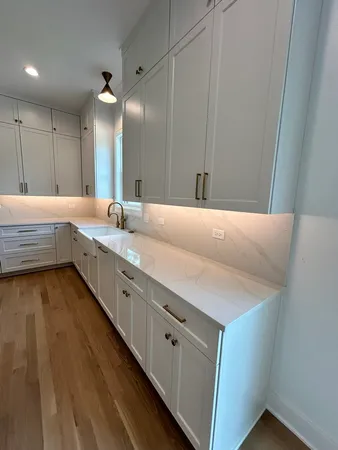 a spacious bathroom with a granite countertop sink and a mirror