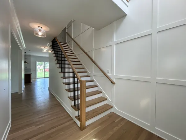 a view of entryway and hall with wooden floor