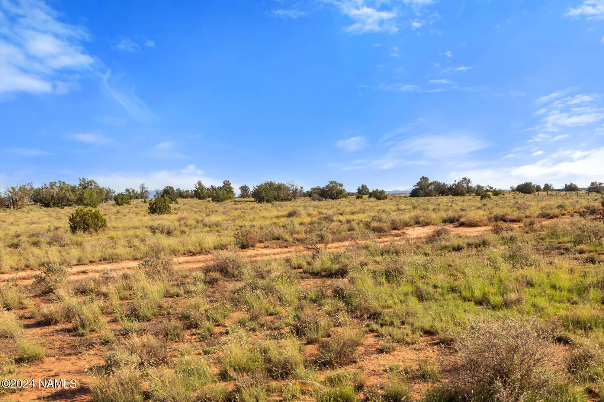 a view of a large building with mountains in the background