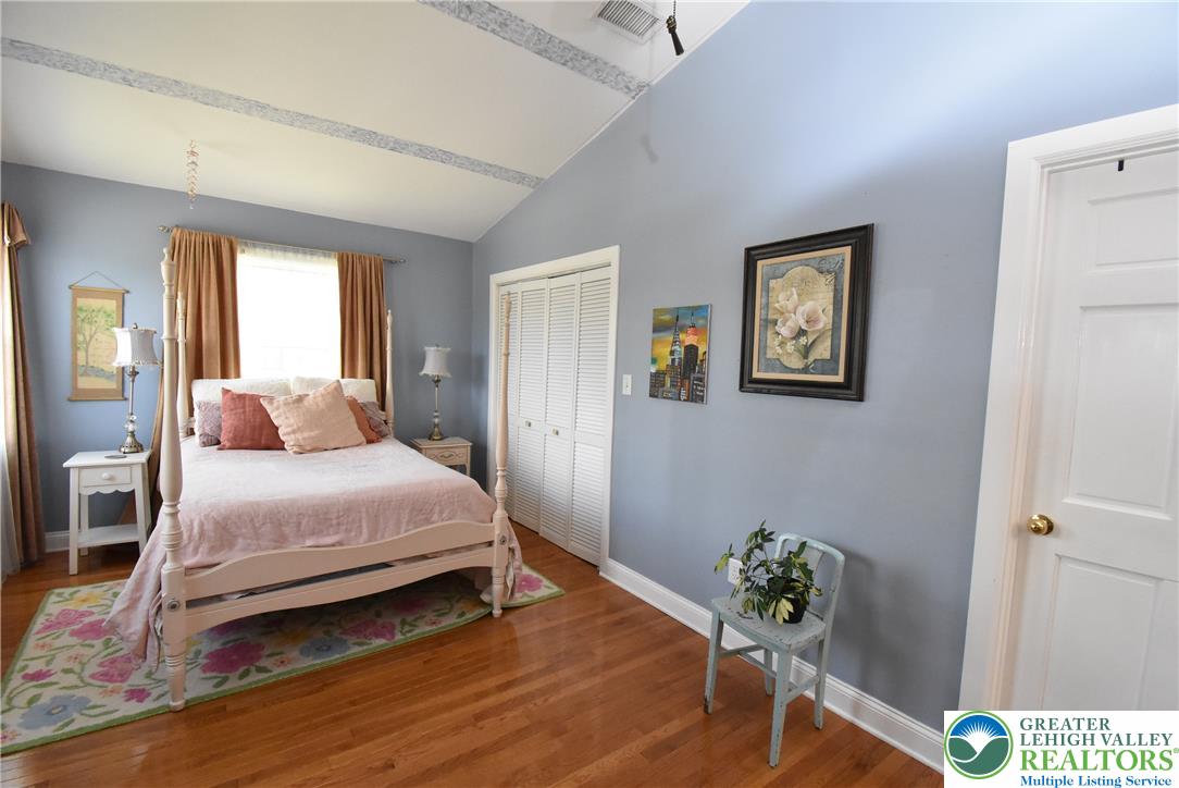 424 Grape Street Whitehall, PA 18052 - Photo 42 of 56 This tranquil bedroom features vaulted ceilings and polished hardwood flooring, creating a comfortable retreat.