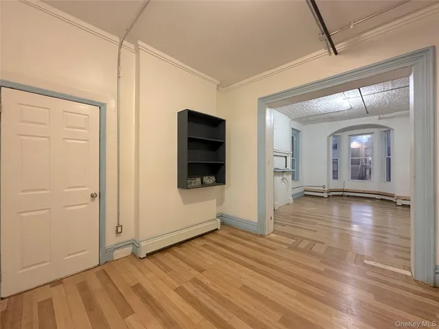 a view of a room with wooden floor and window