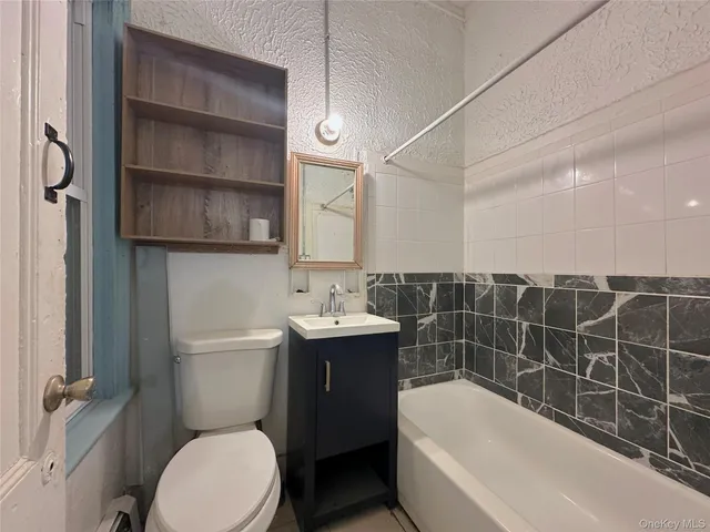 a bathroom with a sink a toilet and bathtub