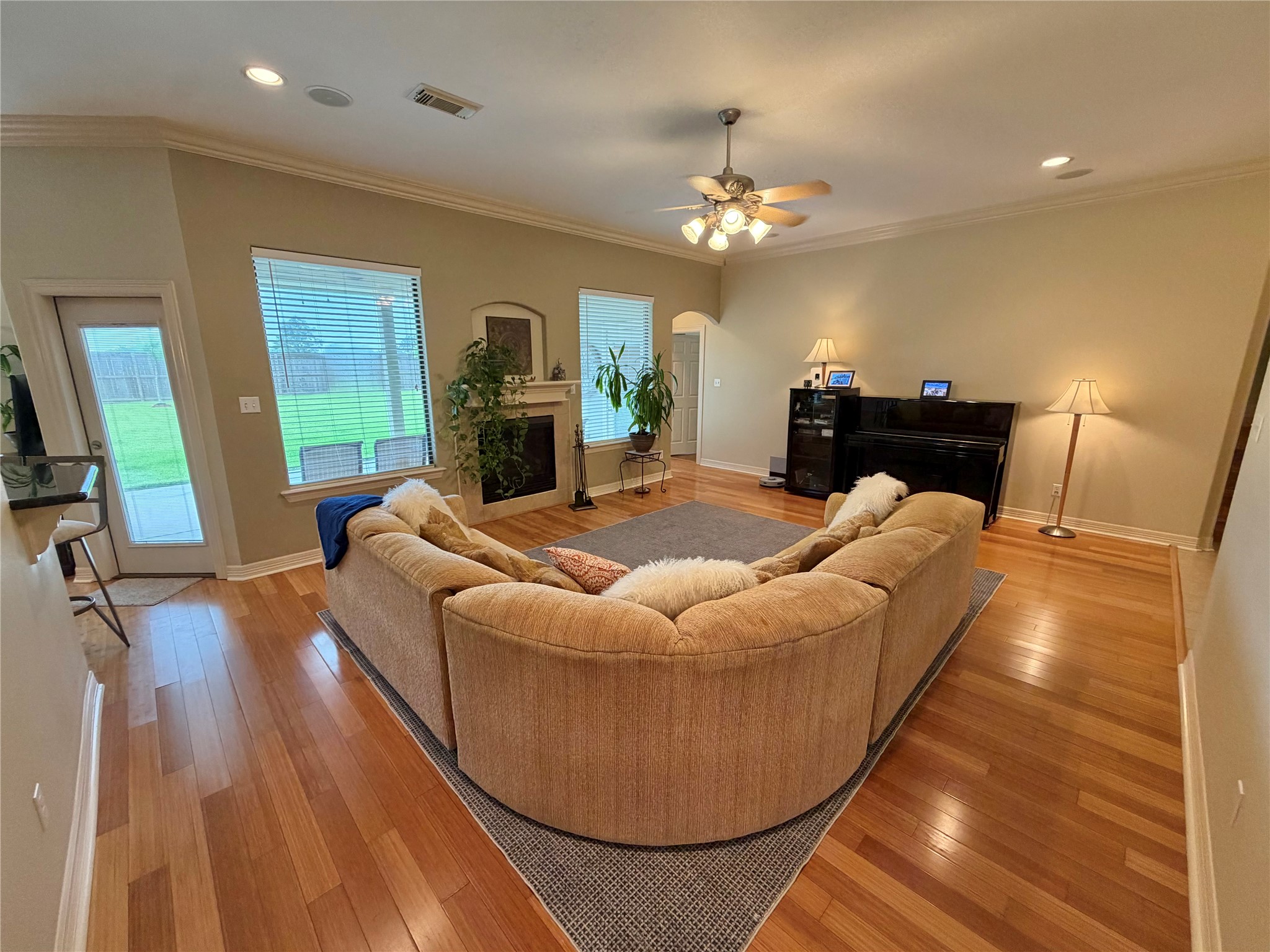 1448 South Blue Bonnet Lane Angleton, TX 77515 - Photo 5 of 43 a living room with furniture a fireplace and a chandelier