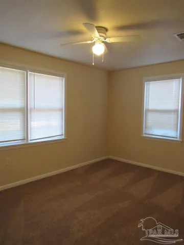 a bathroom with a sink mirror and toilet
