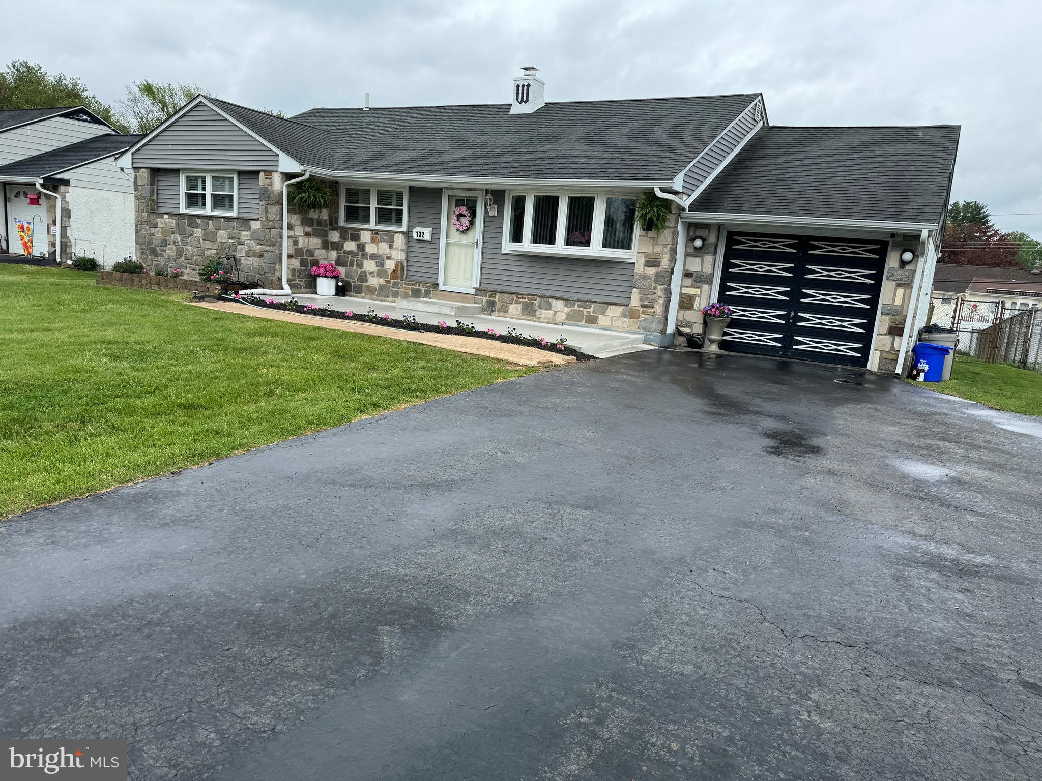 132 Richard Road Aston, PA 19014 - Photo 3 of 19 a front view of a house with a yard and garage