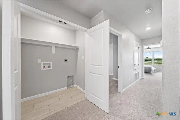 a view of a hallway with closet and wooden floor