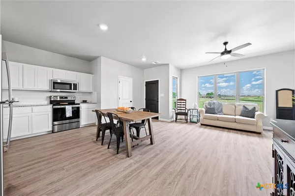 a view of a dining room with furniture window and wooden floor