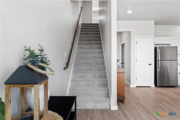 a view of entryway with wooden floor and stairs