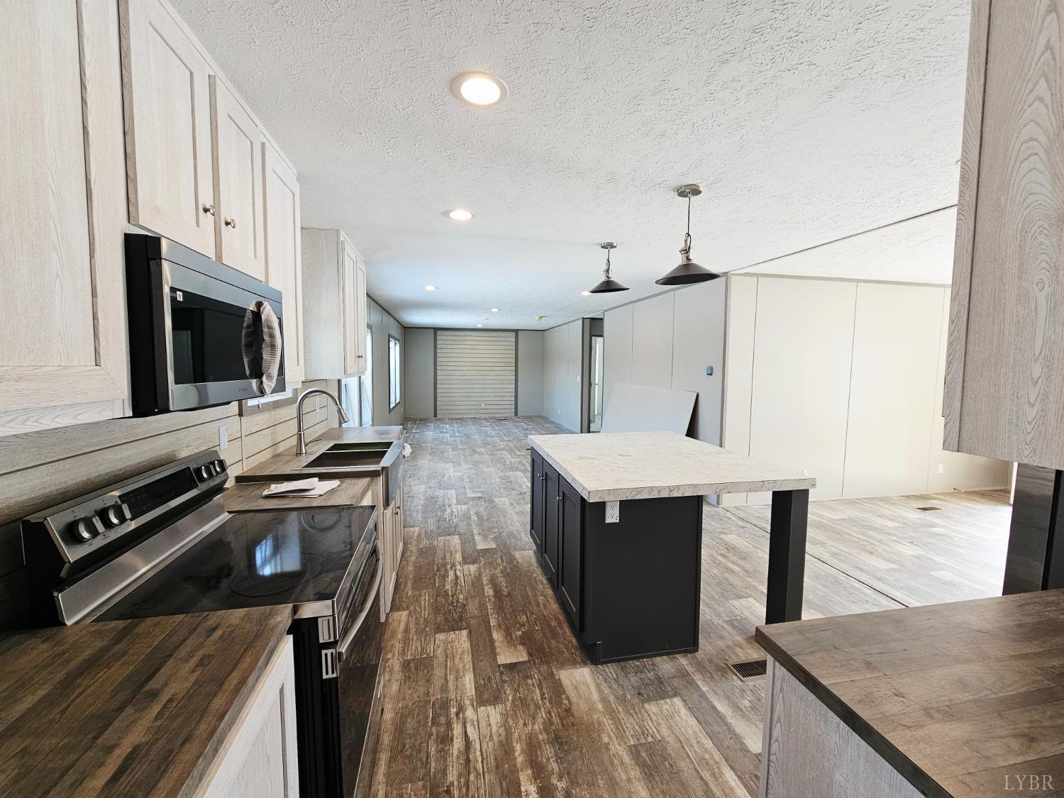 2066 Turkey Mountain Road Amherst, VA 24521 - Photo 3 of 19 a kitchen with a stove a sink and a microwave