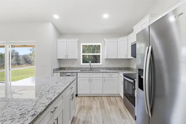 a kitchen with a refrigerator sink and stove