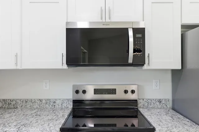 a kitchen with a stove and a microwave