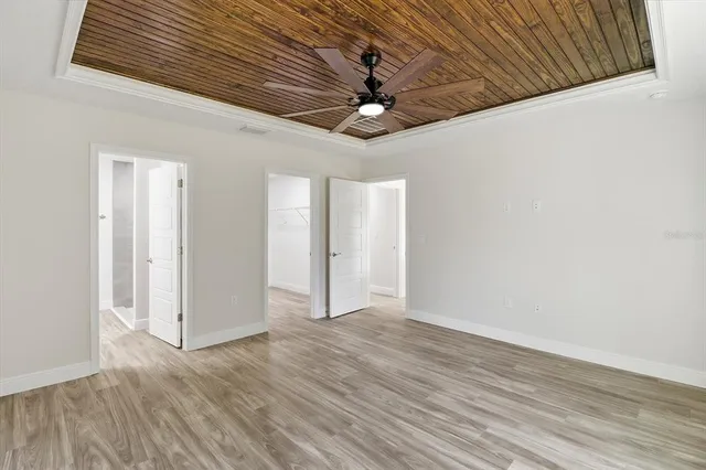 a view of an empty room with wooden floor