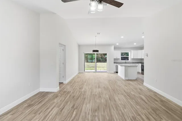 a view of kitchen with wooden floor electronic appliances and window