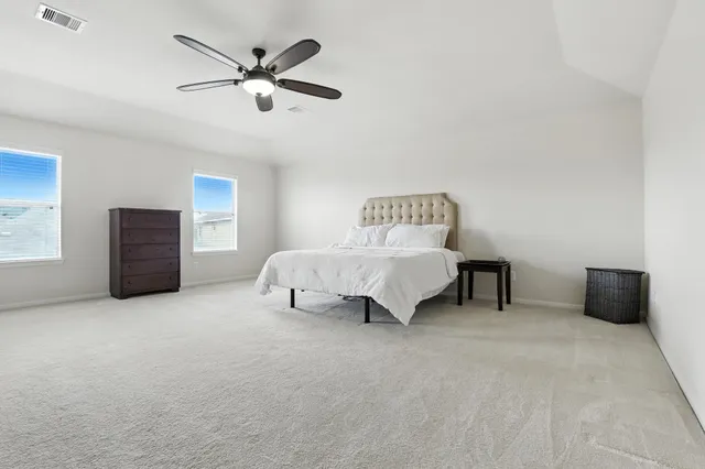 a living room with furniture and ceiling fan