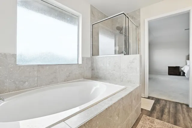 a bathroom with a bathtub and a shower