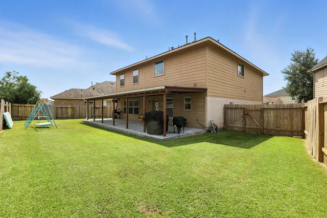 a view of a house with a yard and sitting area