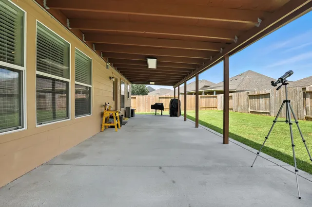 a view of yard with patio