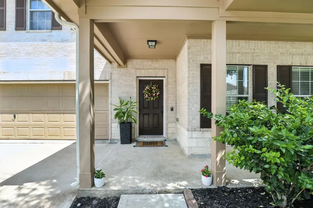 a front view of a house with a plants