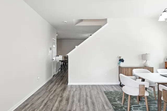 a view of a dining room with furniture and wooden floor