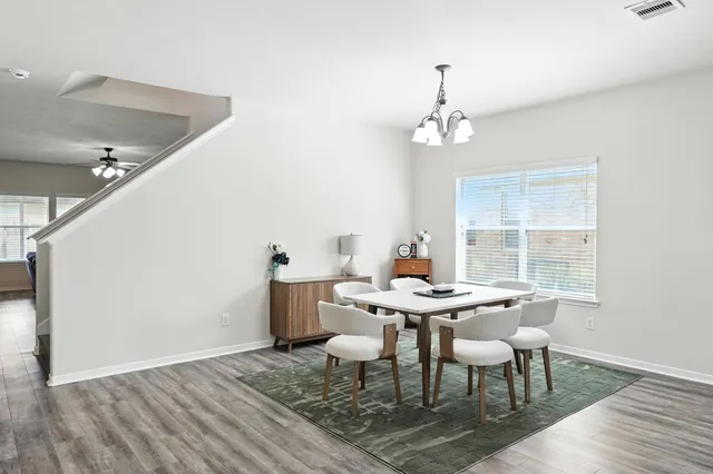 a view of a dining room with furniture window and wooden floor