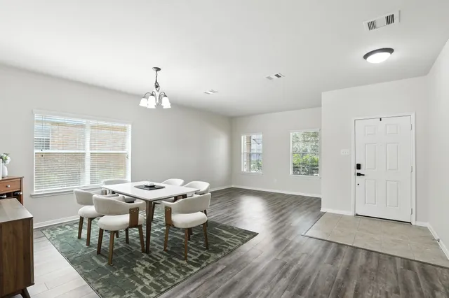 a dining room with furniture and window