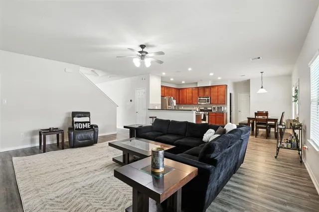 a living room with furniture and wooden floor