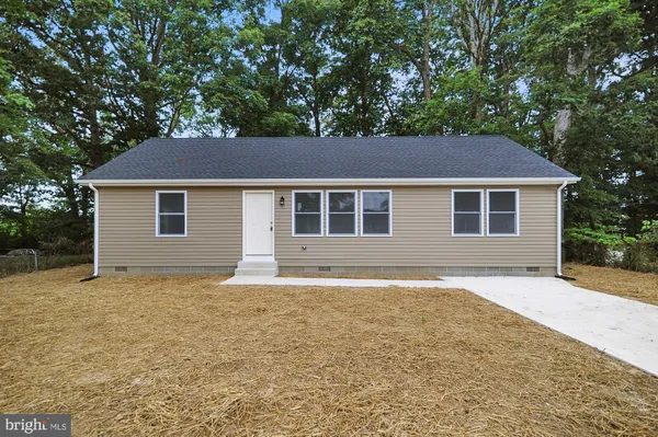 a house that has a tree in front of it