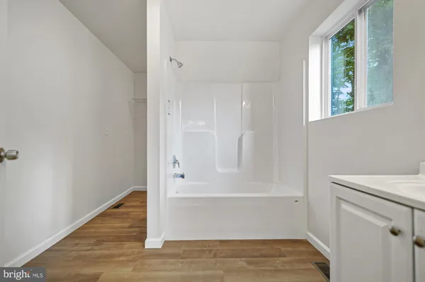 a bathroom with a bathtub and shower