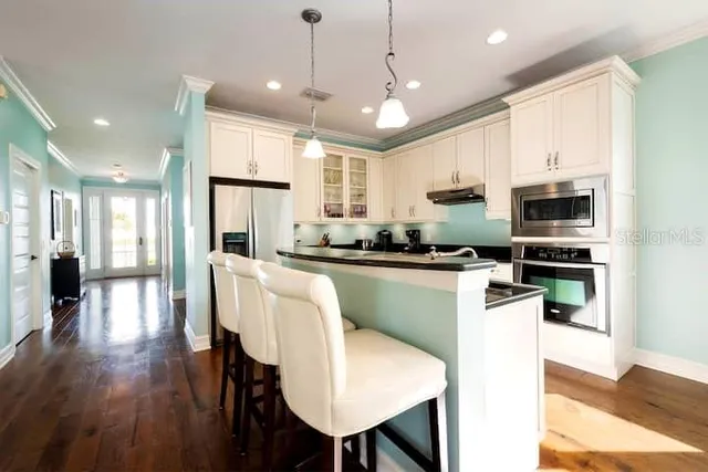 a living room with furniture ceiling fan and a large window