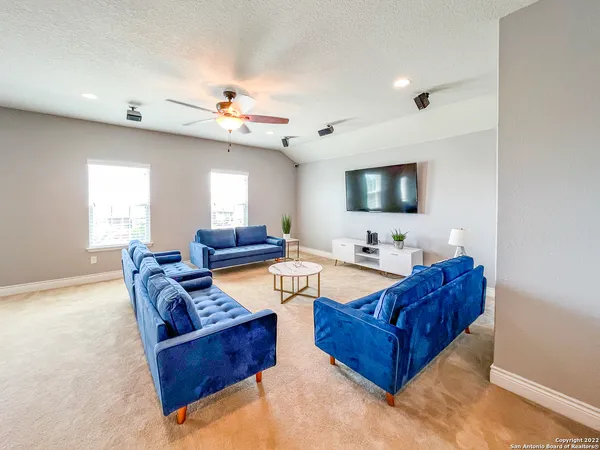 a living room with furniture and kitchen view