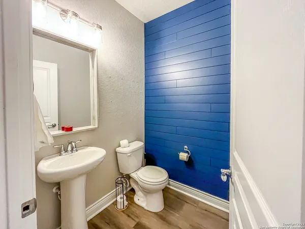 a bathroom with a toilet a sink and mirror