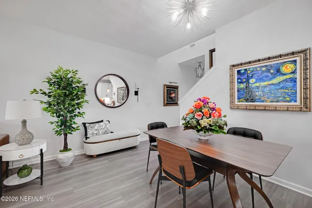 a kitchen with granite countertop a refrigerator stove top oven and sink