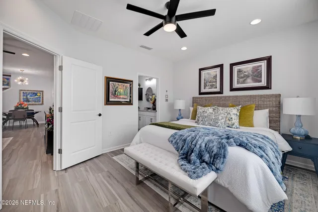 a bathroom with a granite countertop toilet sink and mirror