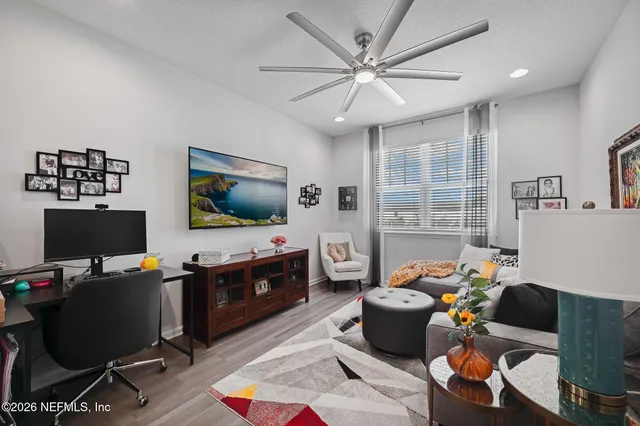 a view of a hallway with wooden floor and cabinet