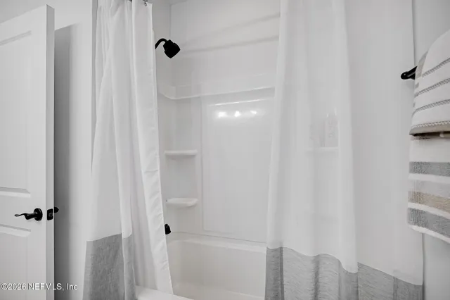 a bedroom with a large bed and a dresser