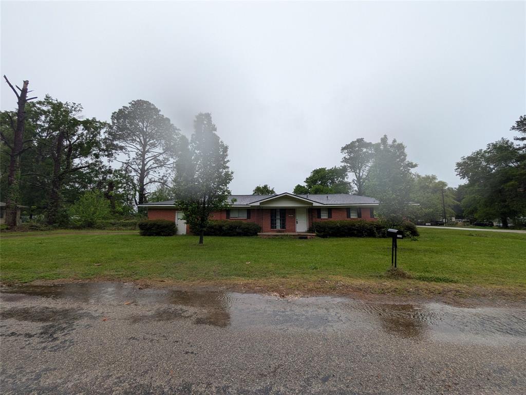 Single story home with a front lawn