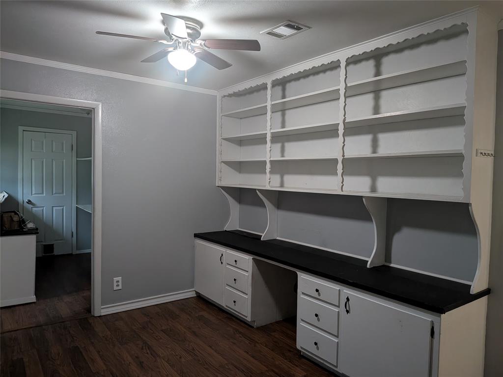 2009 County Road 4619 Athens, TX 75752 - Photo 14 of 36 Unfurnished office featuring a ceiling fan, dark wood-style flooring, crown molding, and built in desk