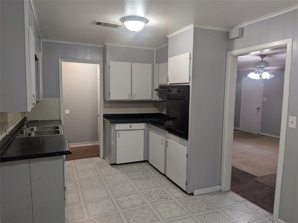 2009 County Road 4619 Athens, TX 75752 - Photo 16 of 36 a kitchen with a refrigerator and white cabinets