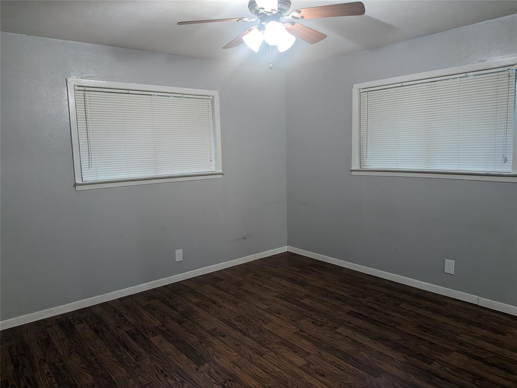 2009 County Road 4619 Athens, TX 75752 - Photo 20 of 36 Unfurnished room featuring ceiling fan and dark wood-style flooring