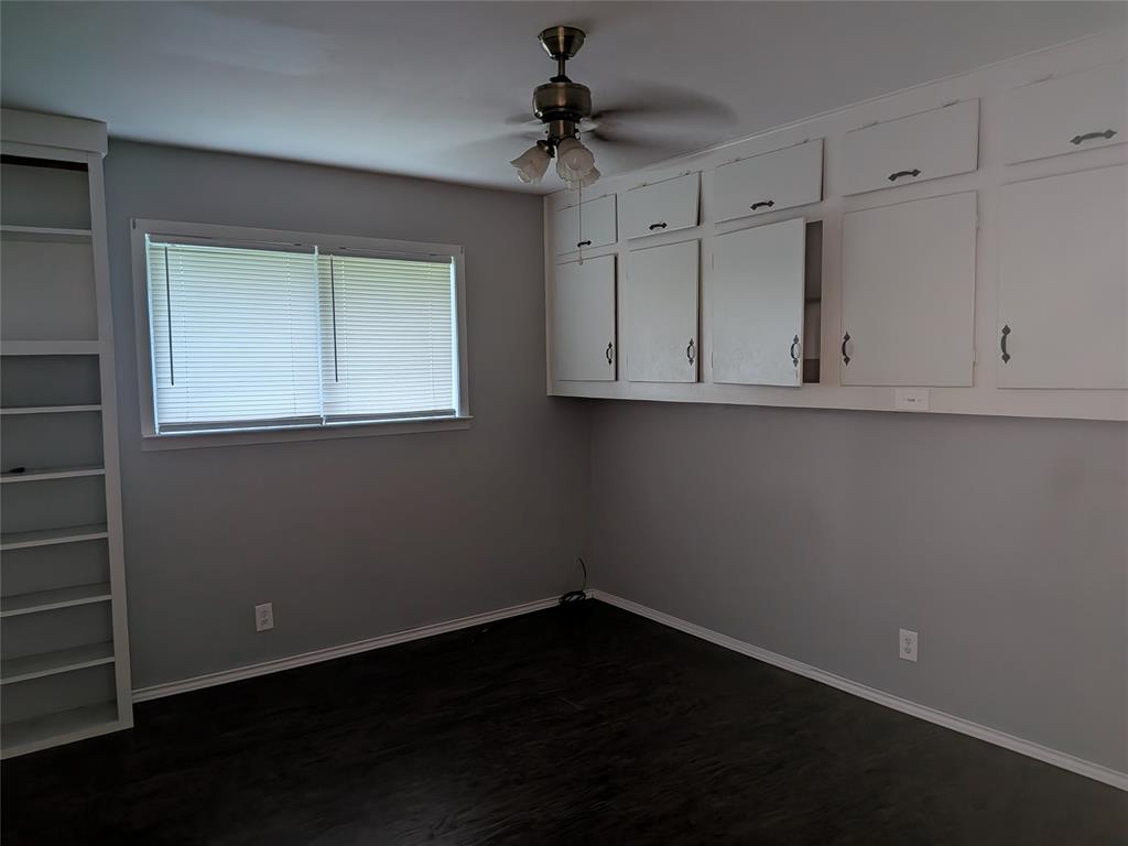 2009 County Road 4619 Athens, TX 75752 - Photo 22 of 36 Unfurnished room featuring a ceiling fan and dark wood-type flooring