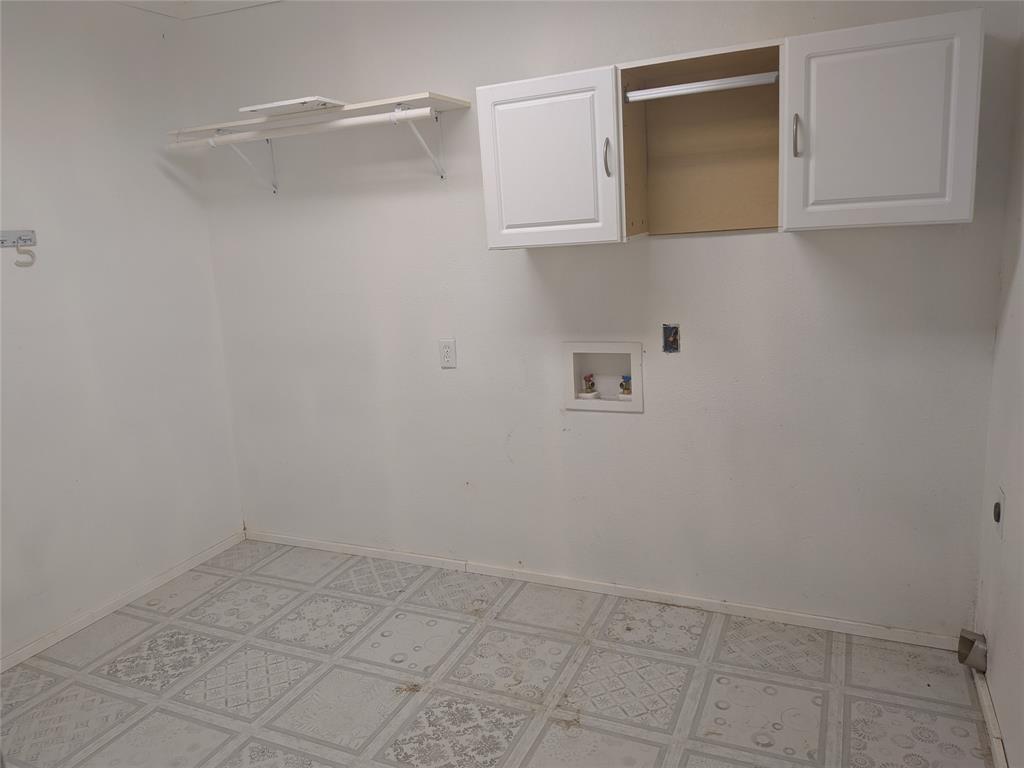2009 County Road 4619 Athens, TX 75752 - Photo 29 of 36 Laundry room with washer hookup, cabinet space, and light flooring