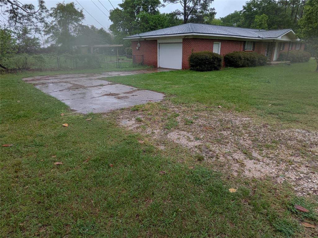 2009 County Road 4619 Athens, TX 75752 - Photo 3 of 36 Single story home with brick siding, a garage, and a front lawn