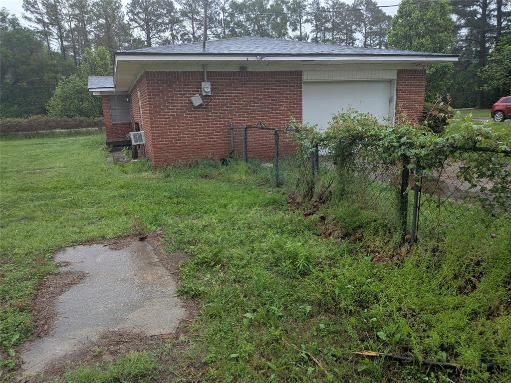 2009 County Road 4619 Athens, TX 75752 - Photo 9 of 36 View of side of property with brick siding and an attached garage