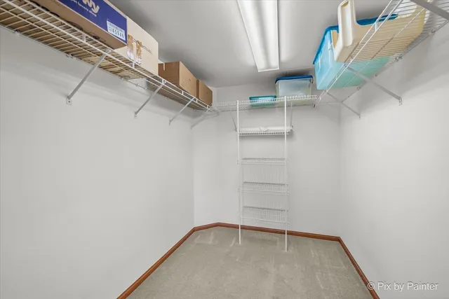 a view of walk in closet with empty racks