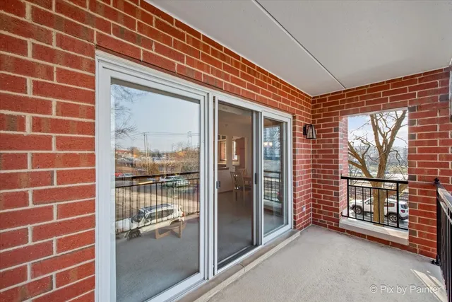 a view of a brick wall next to a window