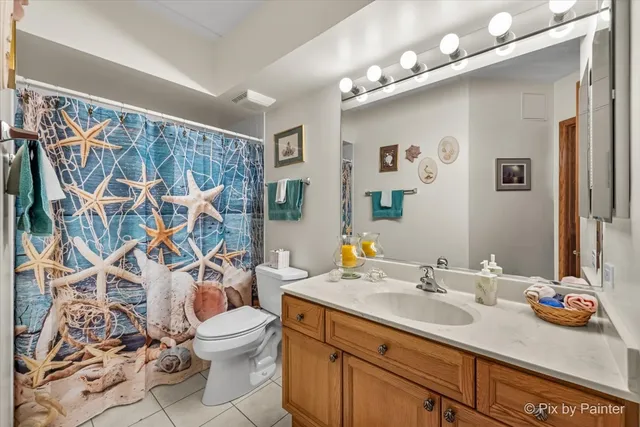 a bathroom with a sink vanity mirror and toilet