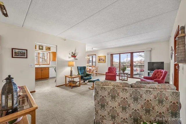 a living room with furniture a flat screen tv and a large window