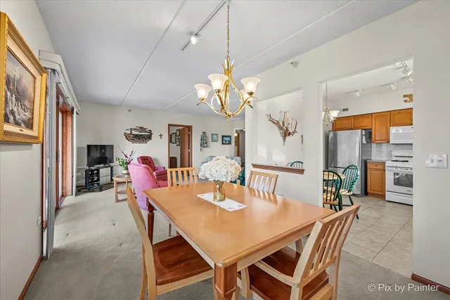a view of a dining room with furniture and a chandelier