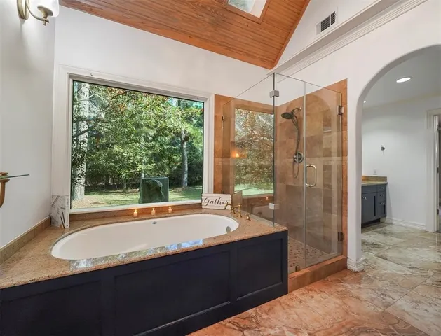 a bathroom with a tub and a sink